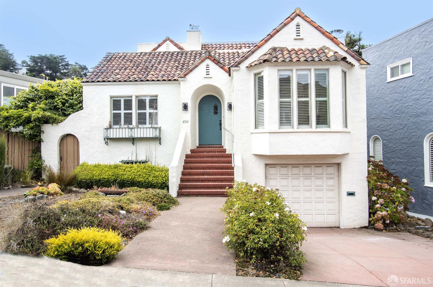 a front view of a house with garden