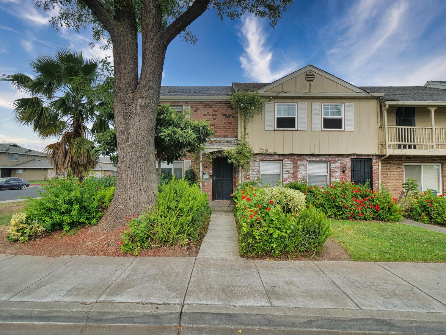 a front view of a house with garden