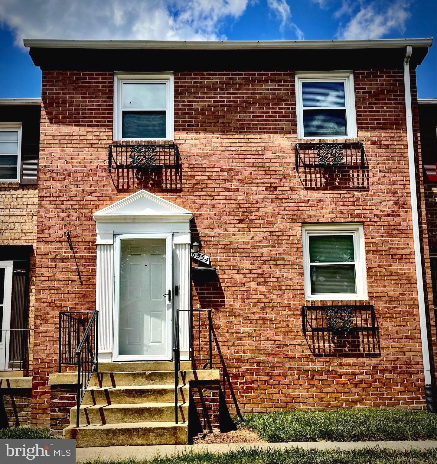 a front view of a house with large windows