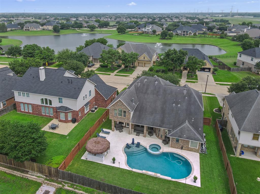 an aerial view of a house with outdoor space and lake view