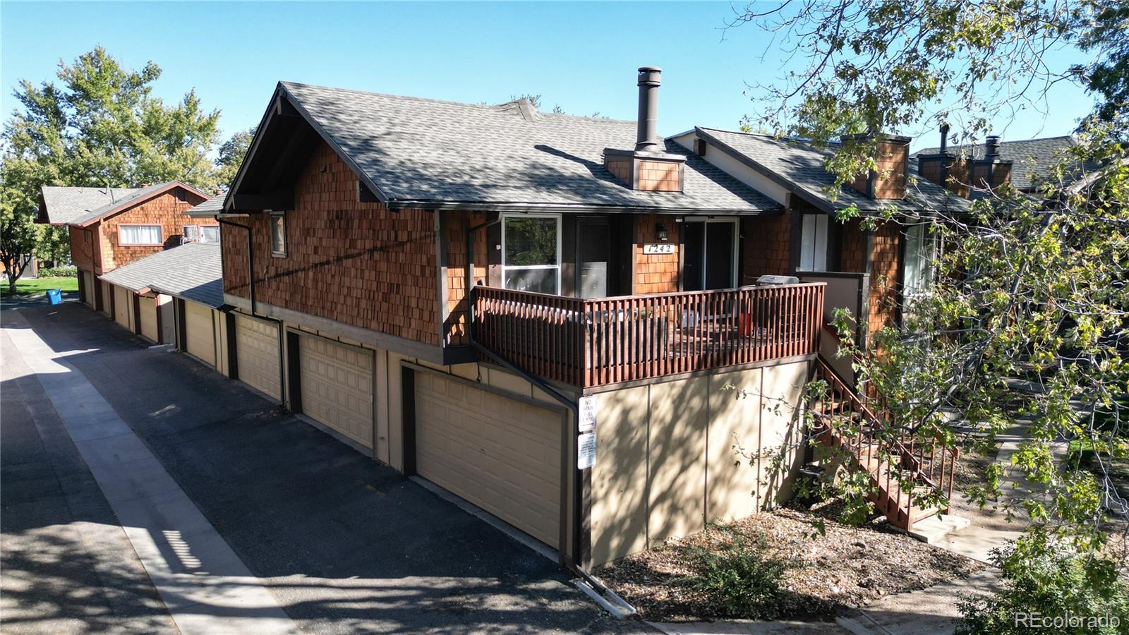 a front view of house with yard and trees in the background