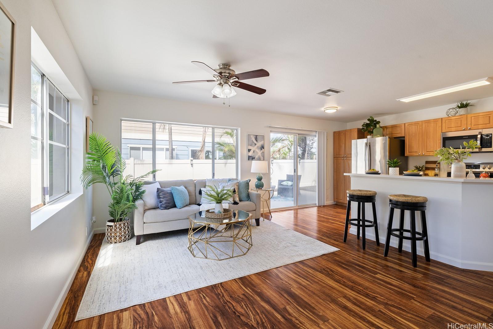 a living room with furniture dining table and a large window