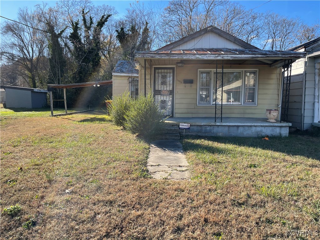 Bungalow-style house with covered porch and a fron