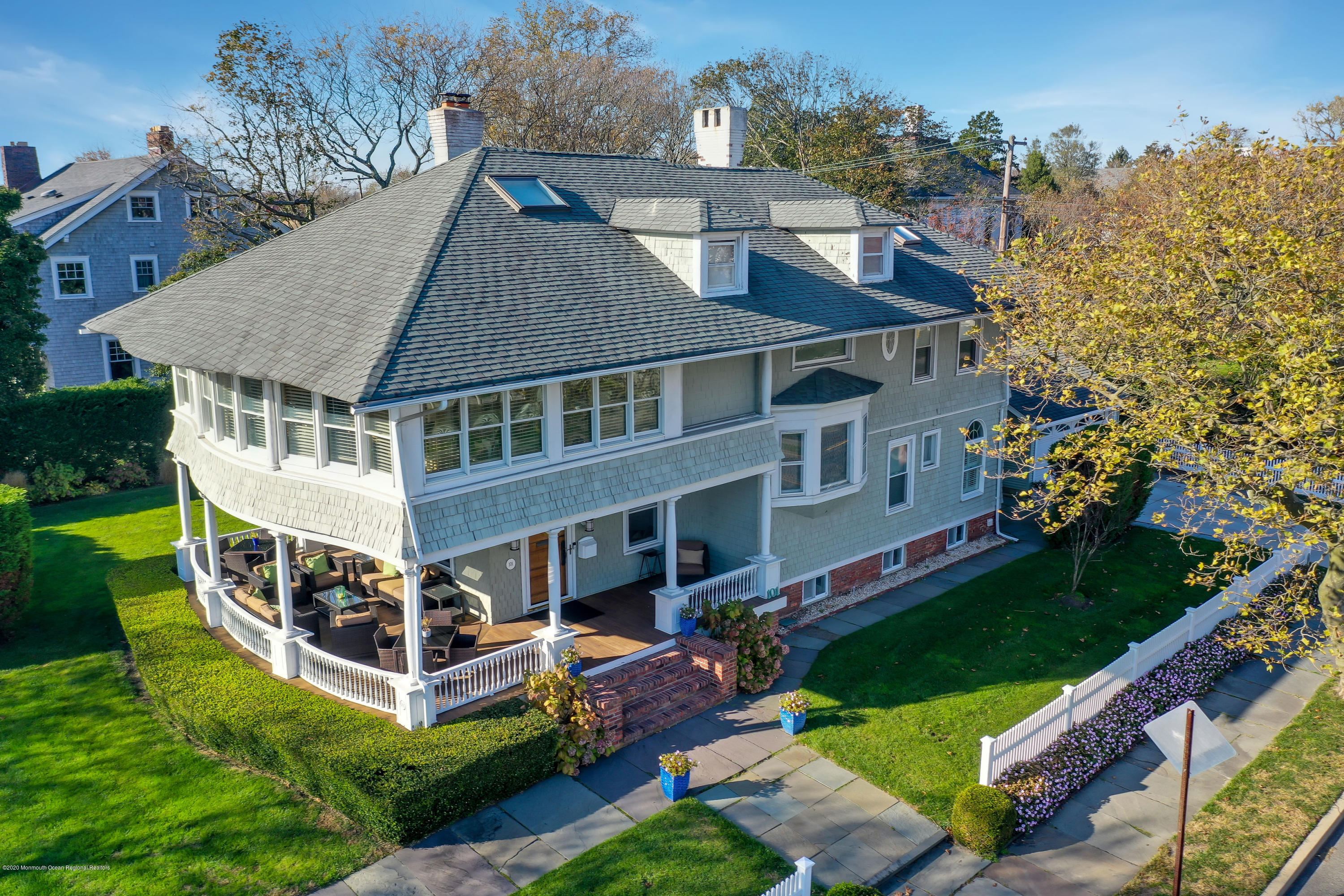 an aerial view of a house with a yard table and chairs