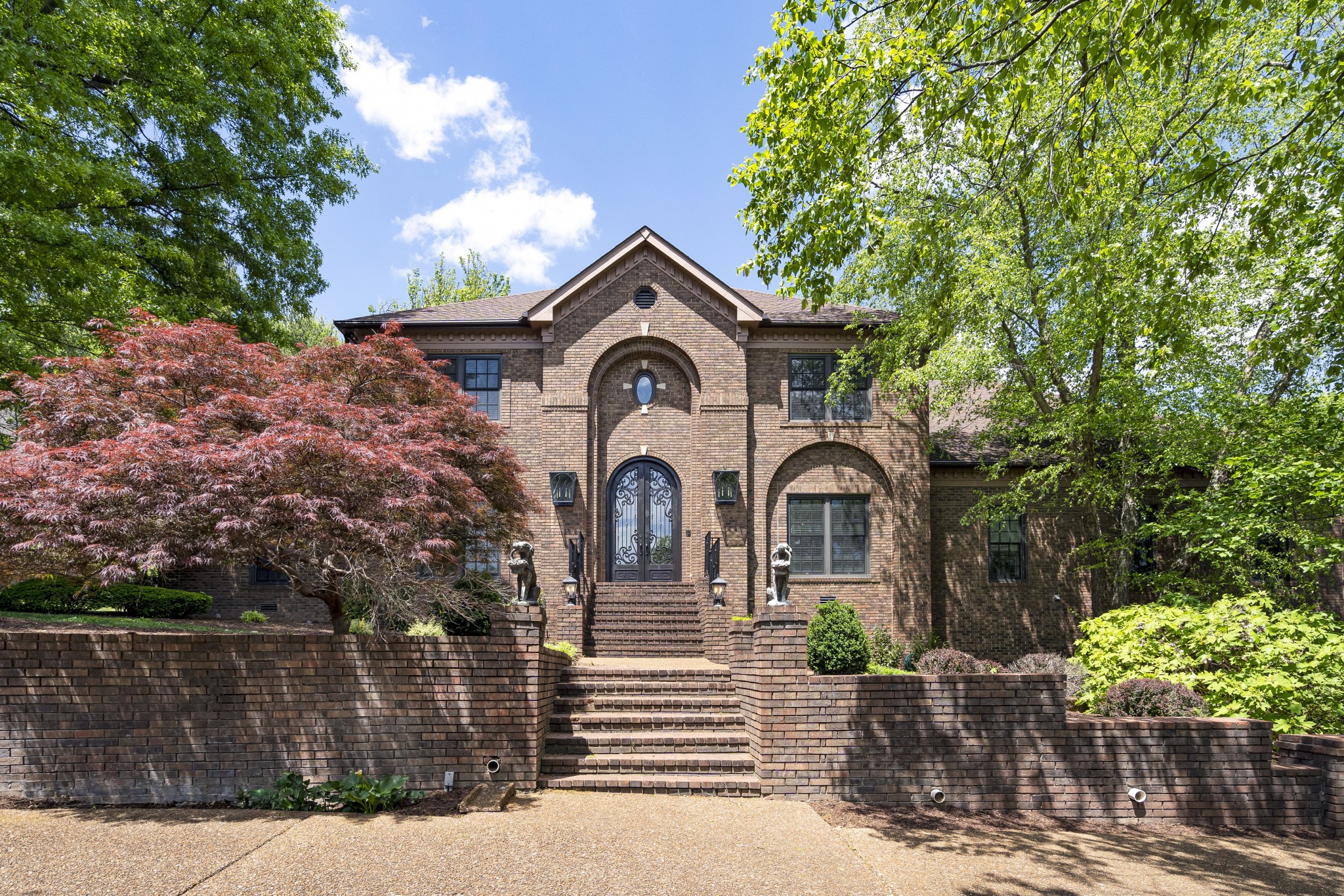 a front view of a house with garden