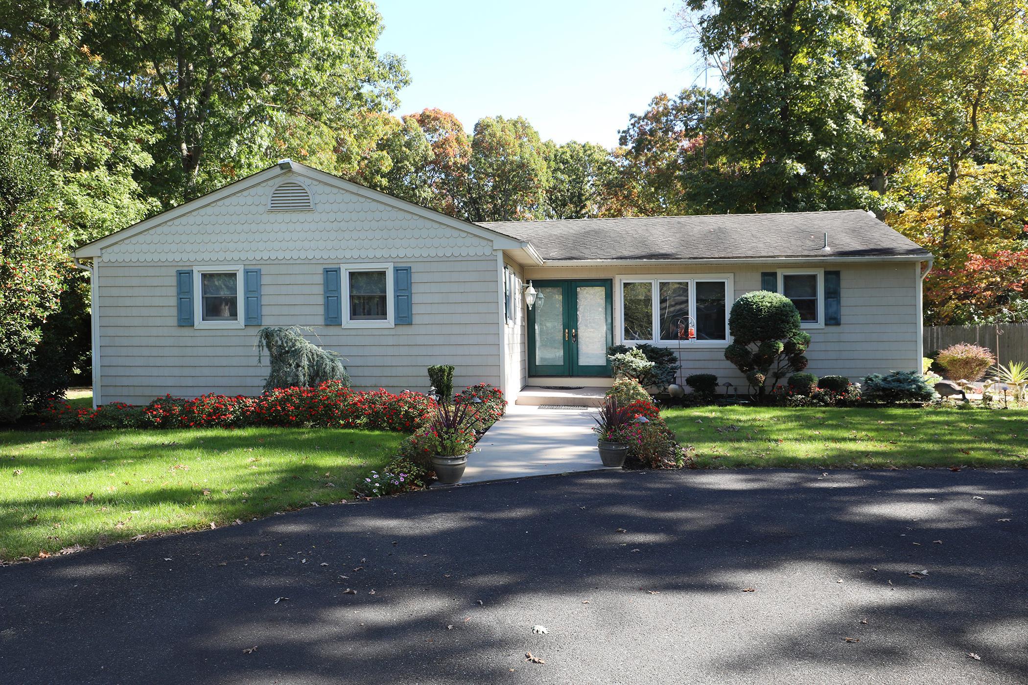 a front view of house with yard and green space