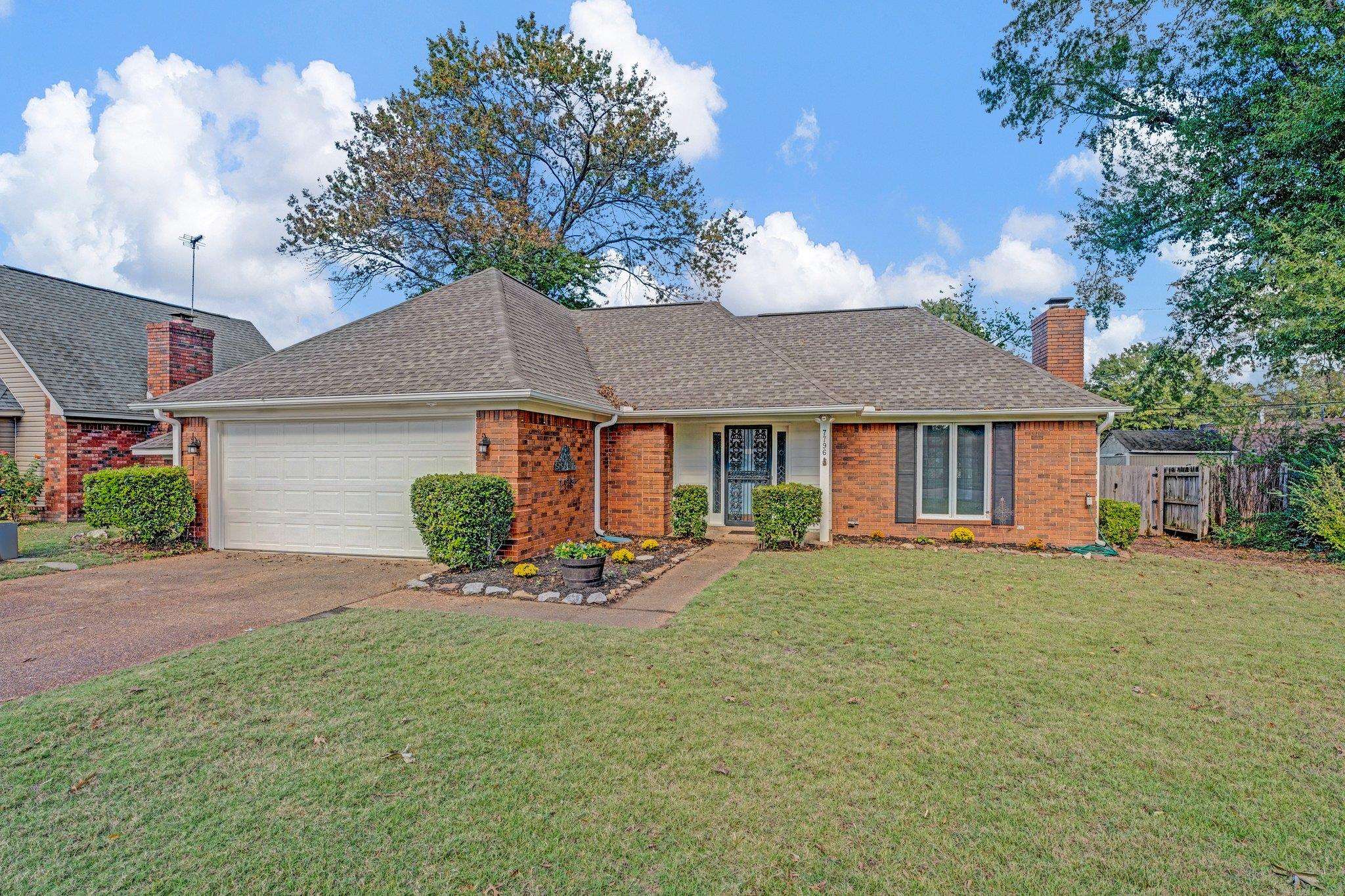 a front view of a house with a yard patio and fire pit