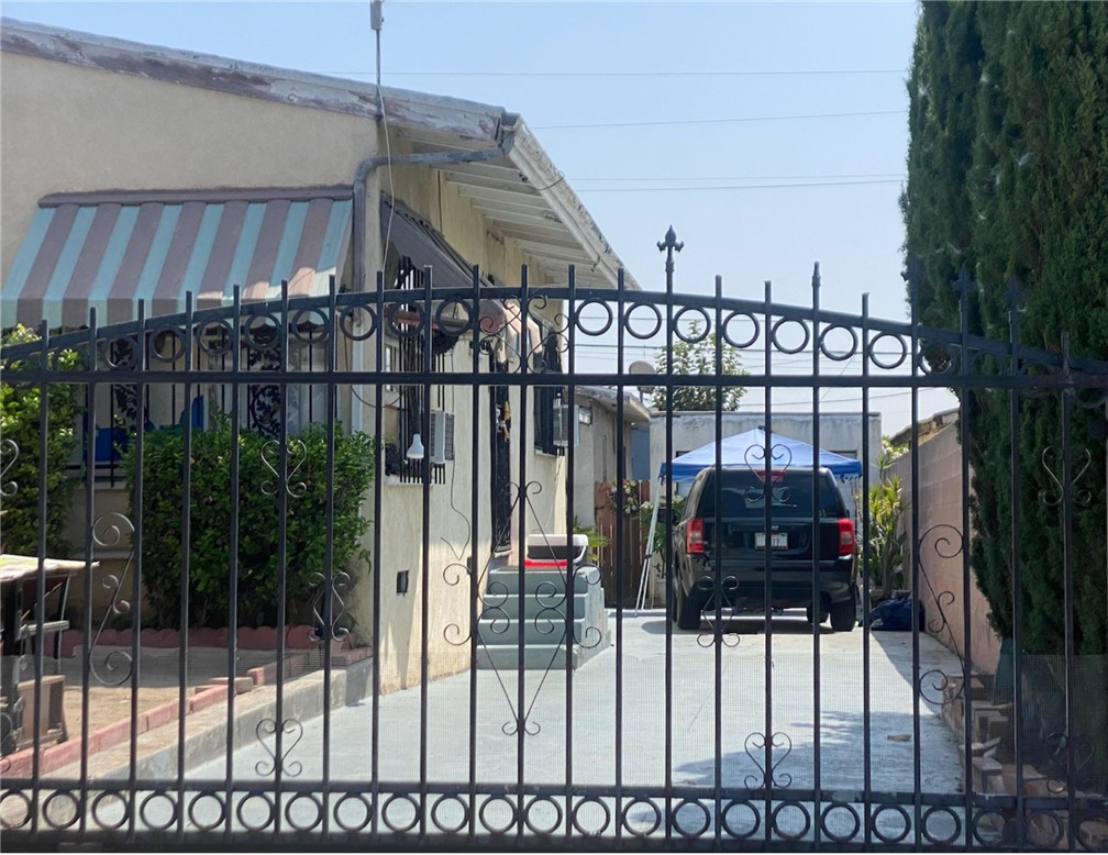 a view of a house with iron fence