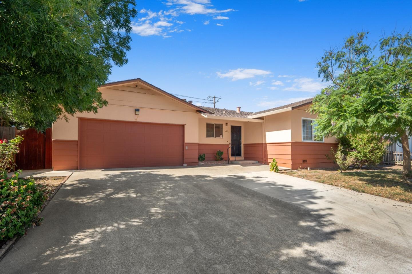 a view of a house with a yard and garage