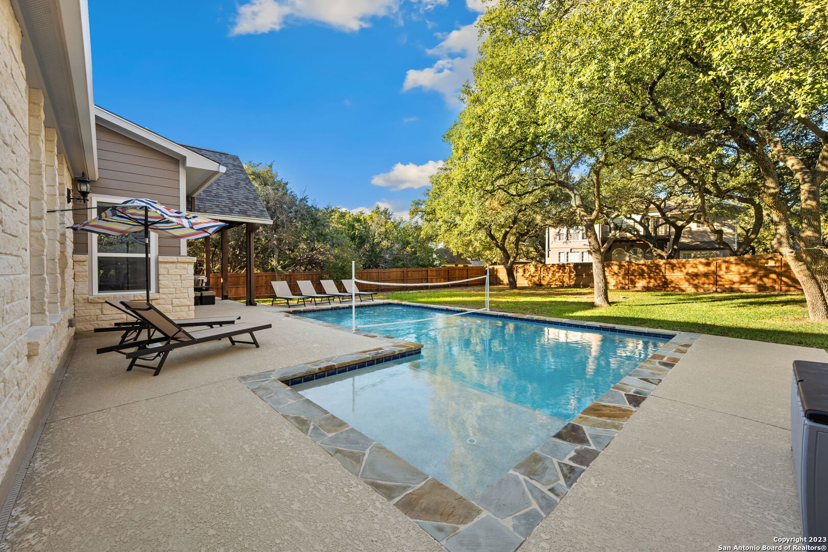 a view of swimming pool with chairs