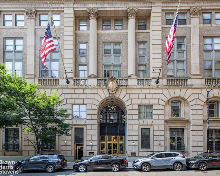 a front view of a building with parking space