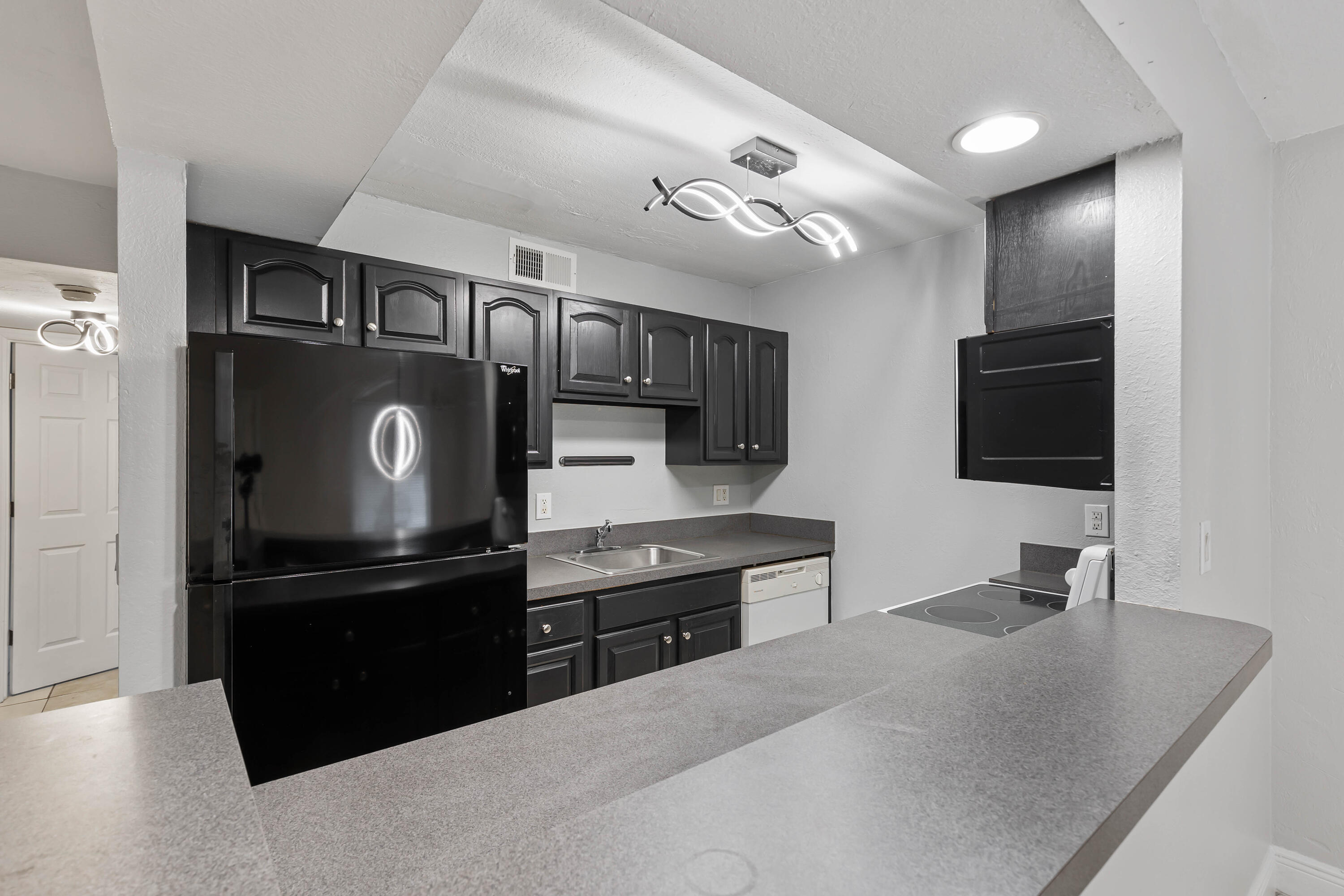 a kitchen with stainless steel appliances granite countertop a refrigerator and a sink