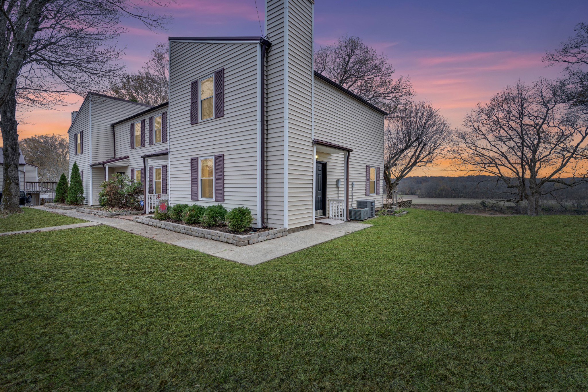 a front view of house with yard and green space