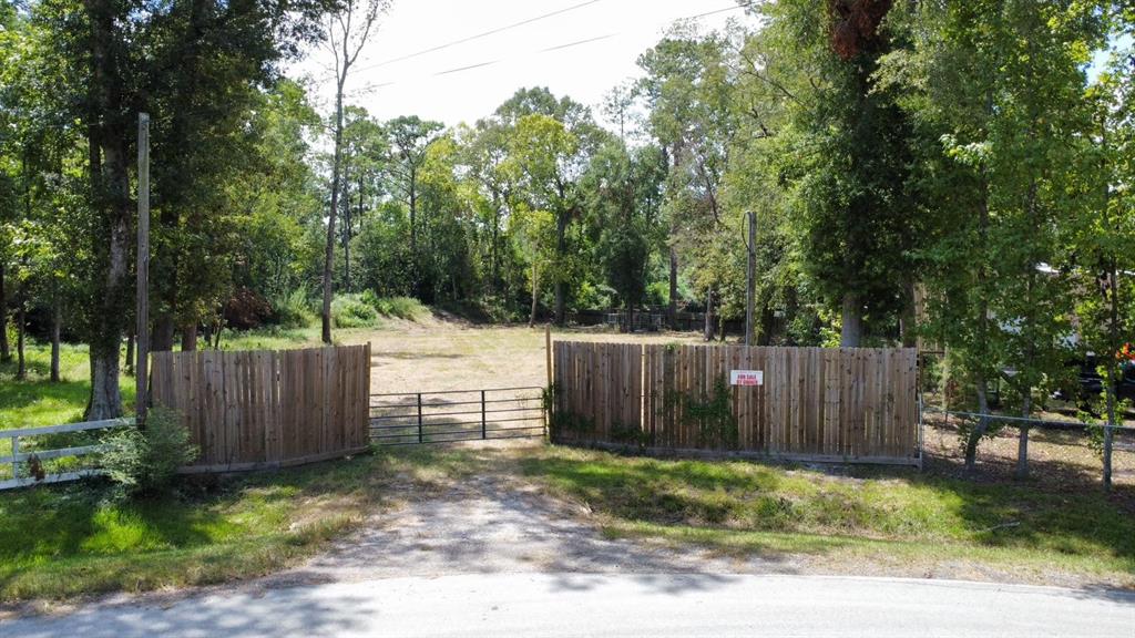 a view of small yard with wooden fence