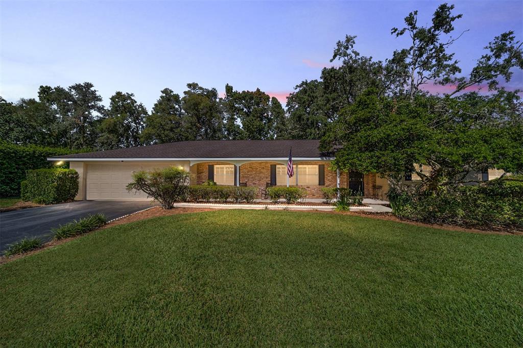 a view of a house with backyard and sitting area