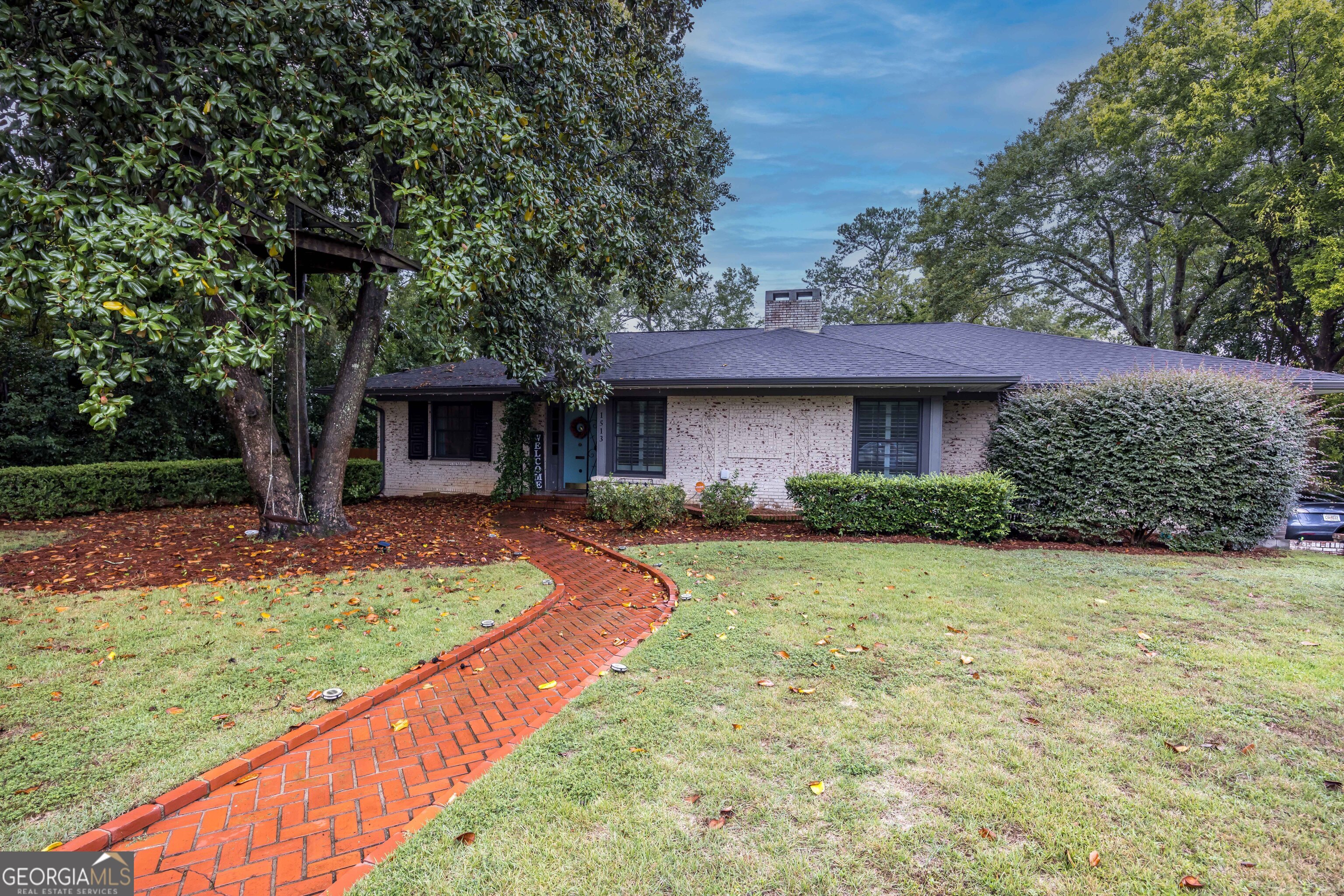 a front view of a house with garden