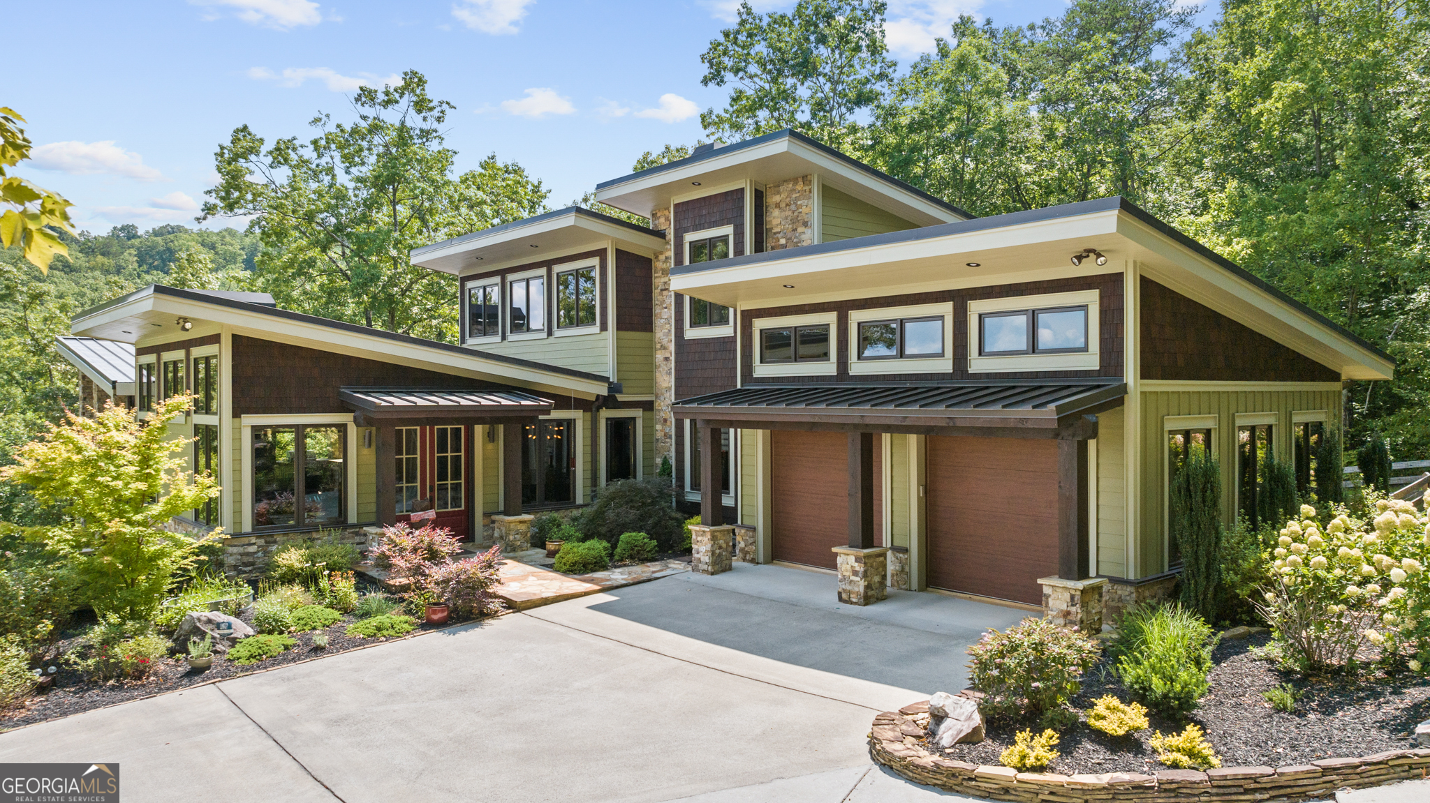 a front view of a house with a yard and potted plants