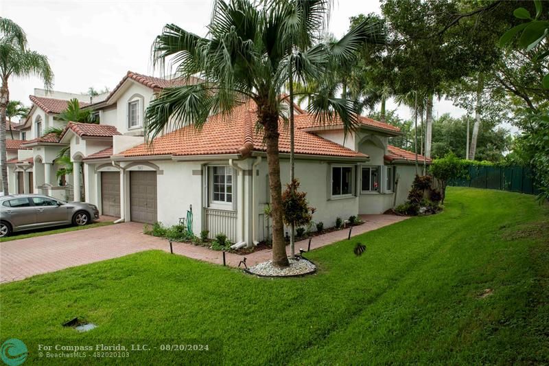 a view of a house with a yard and sitting area