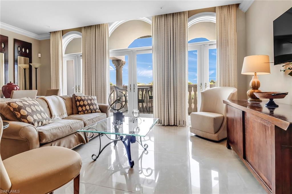 Tiled living room featuring french doors and ornamental molding