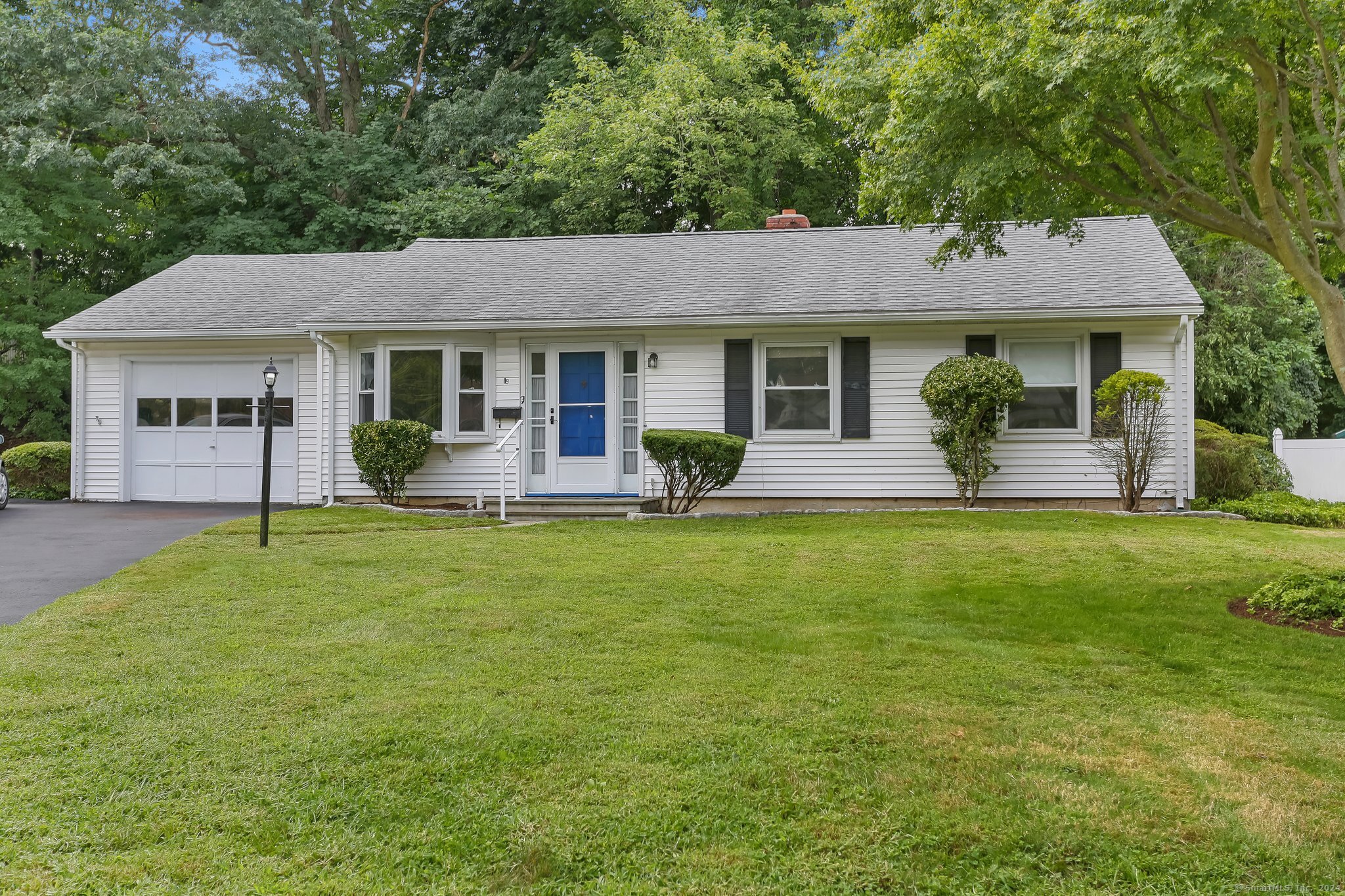 a front view of house with yard and green space