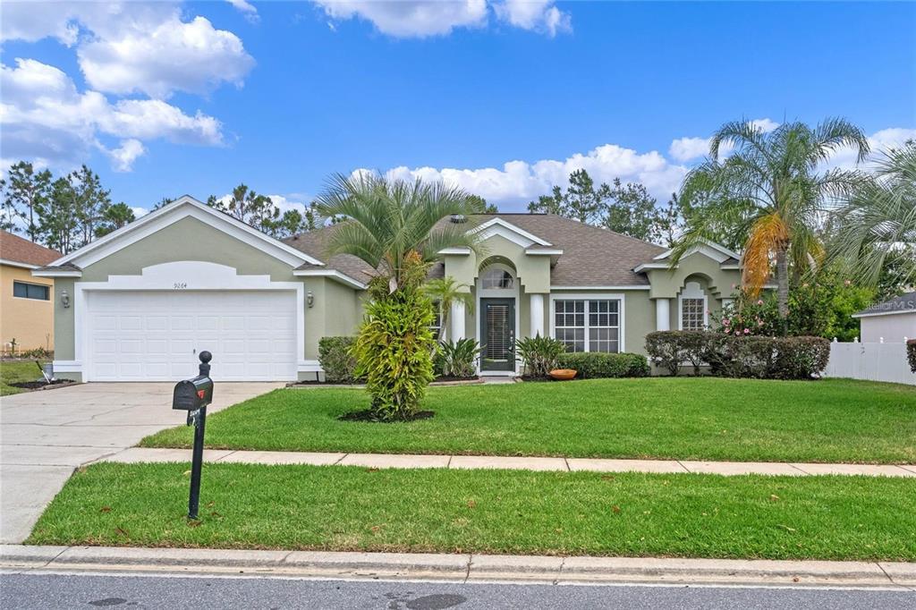 a front view of a house with a yard