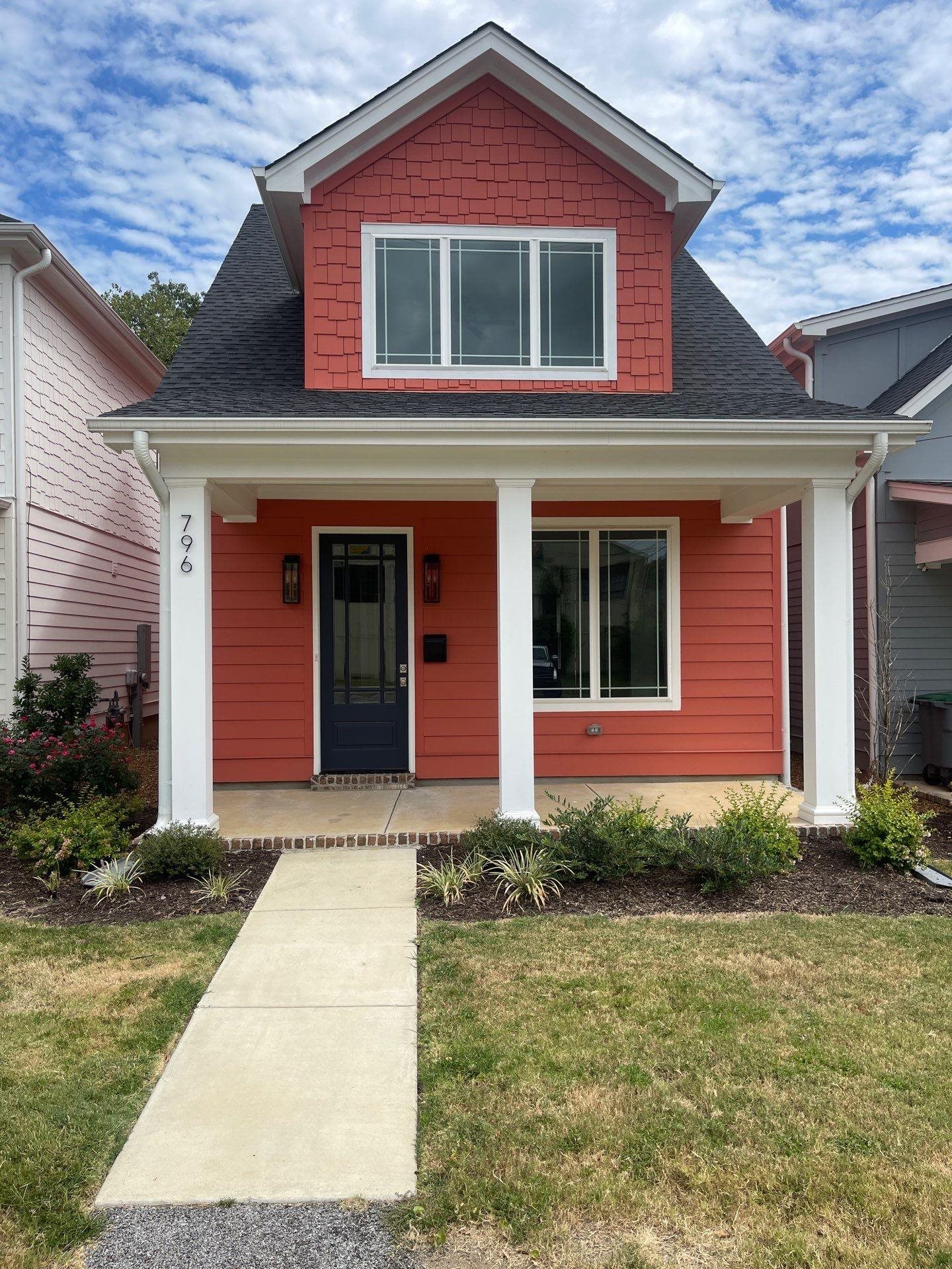 a front view of a house with garden