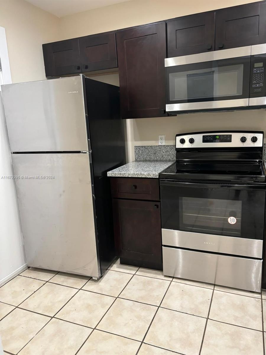 a kitchen with a stove and a refrigerator