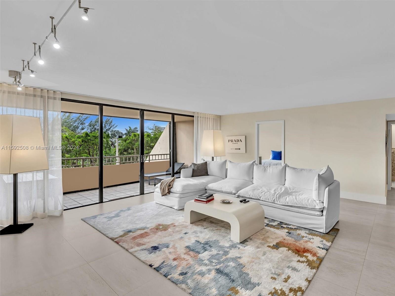 a living room with furniture and large window