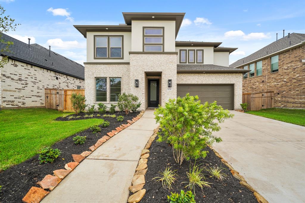 a front view of a house with a garden