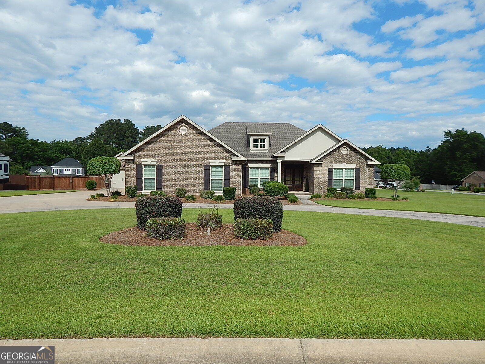 a front view of house with yard and green space