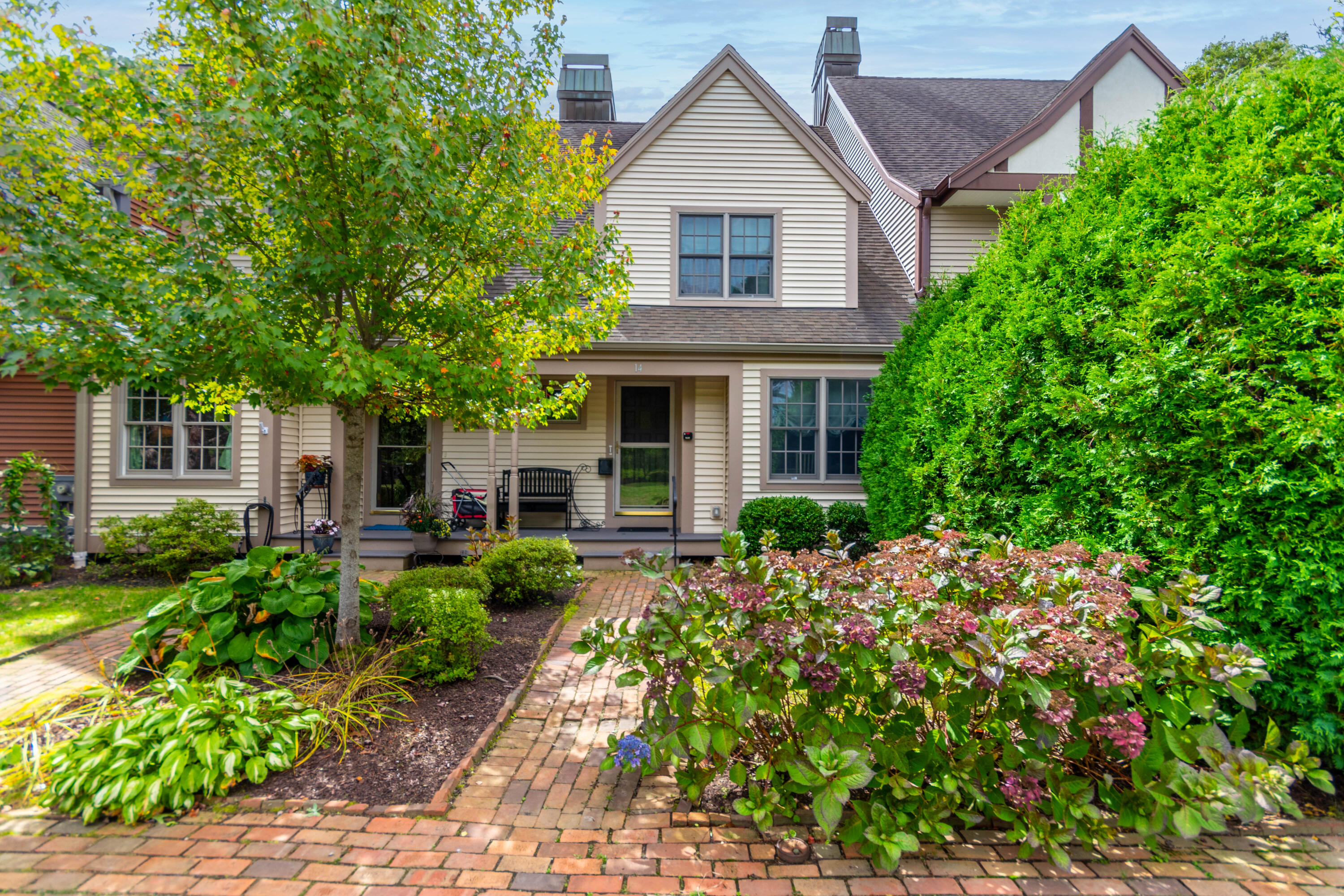 Front of condo with brick walkway