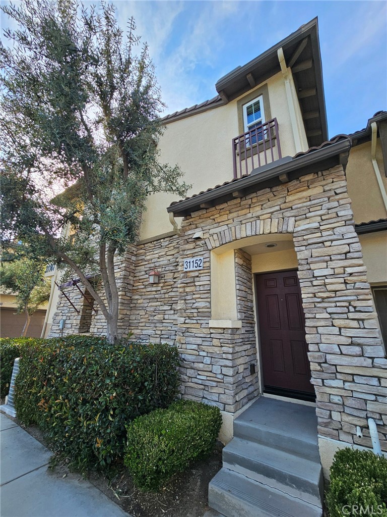 a front view of a house with stairs