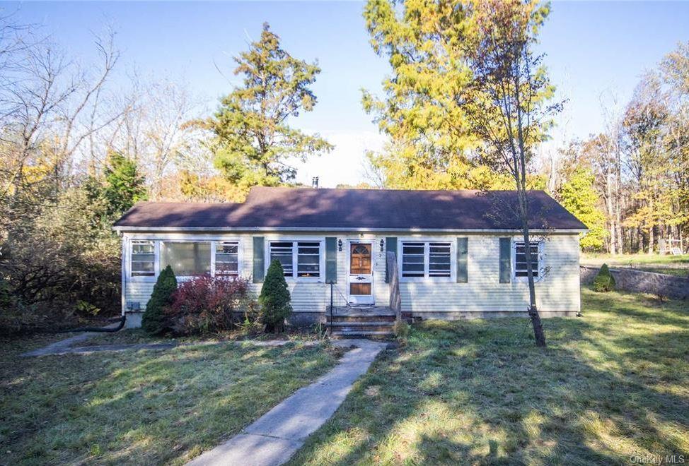 Single story home with a front yard