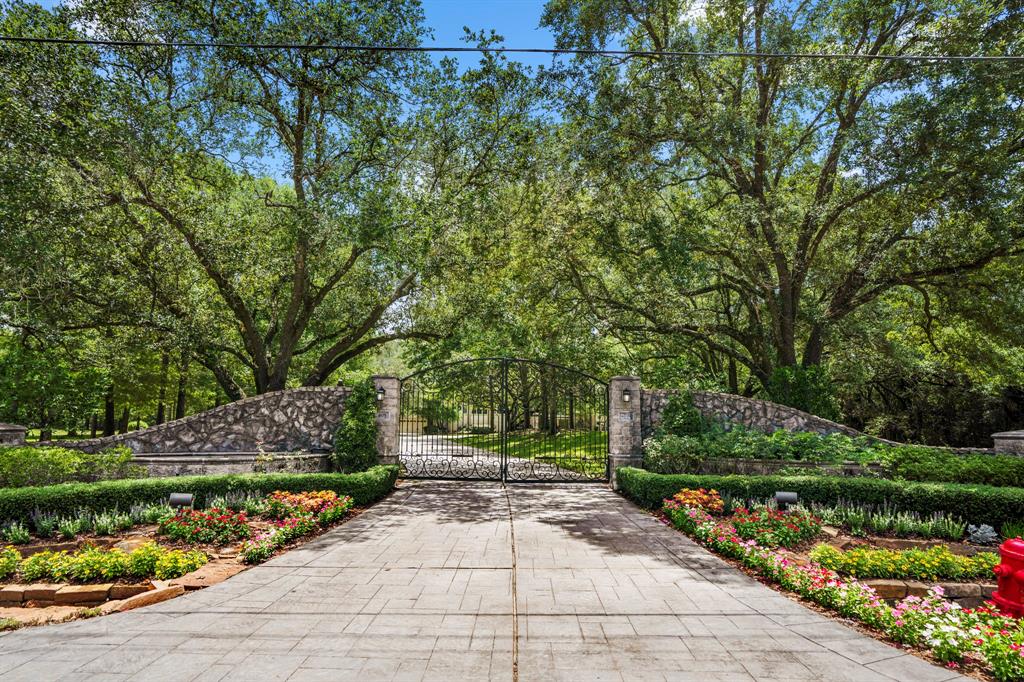 Tucked behind a private entry, a scenic winding driveway leads you to the home surrounded by rich greenery