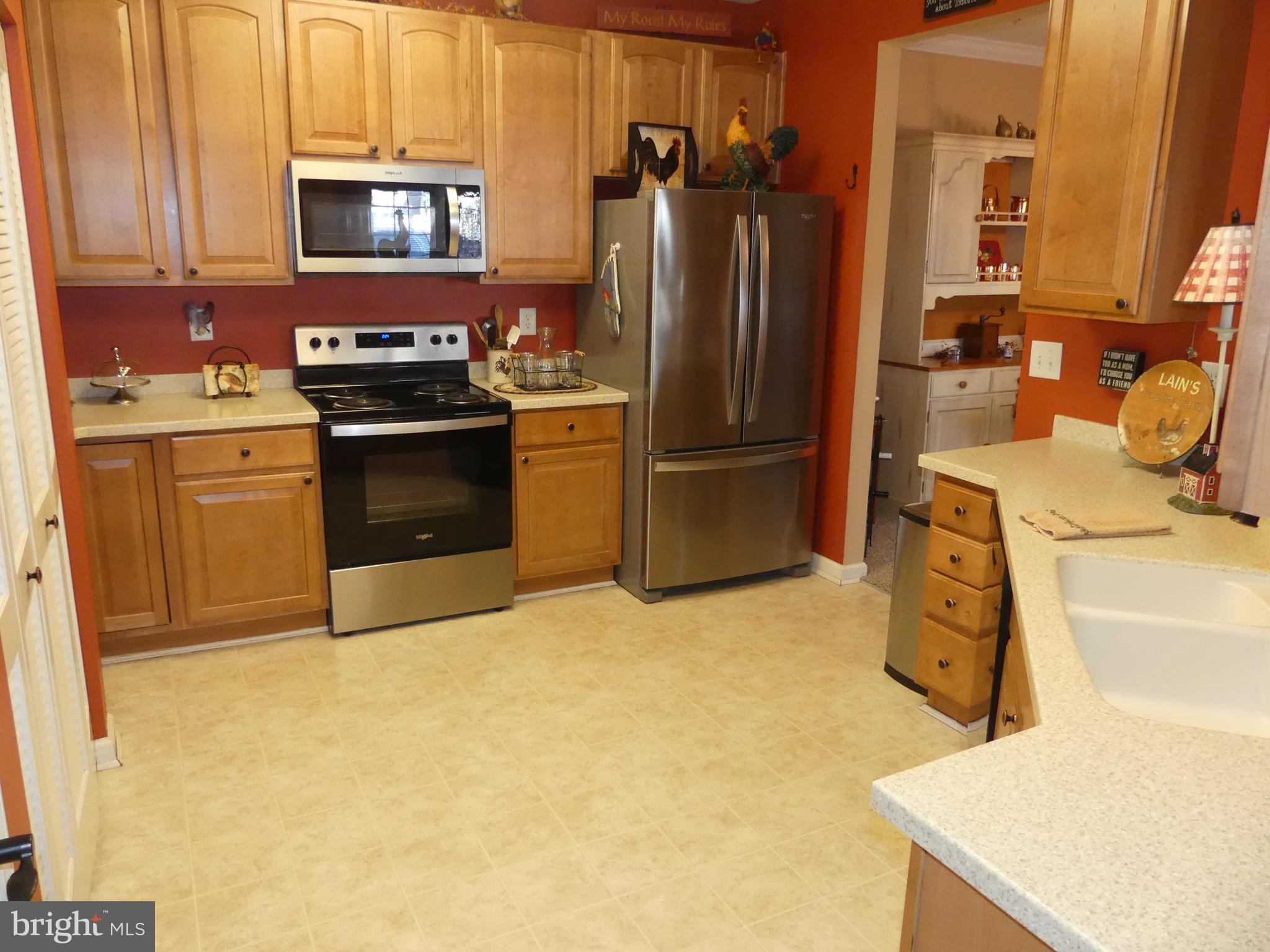 a kitchen with a refrigerator sink and stove