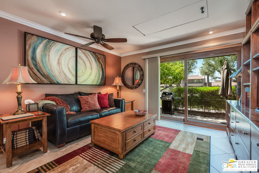 a living room with furniture and a floor to ceiling window