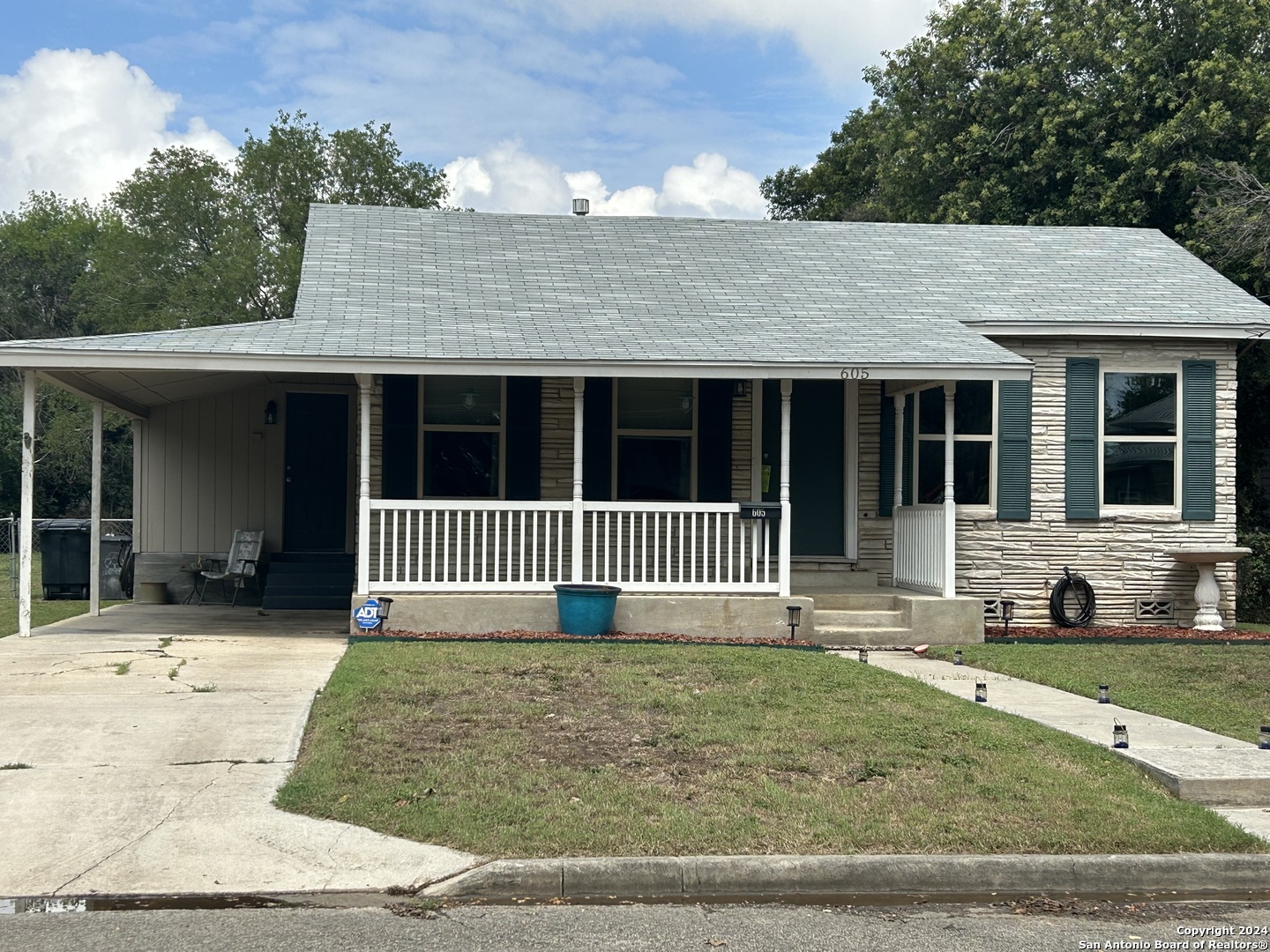 a front view of a house with a garden