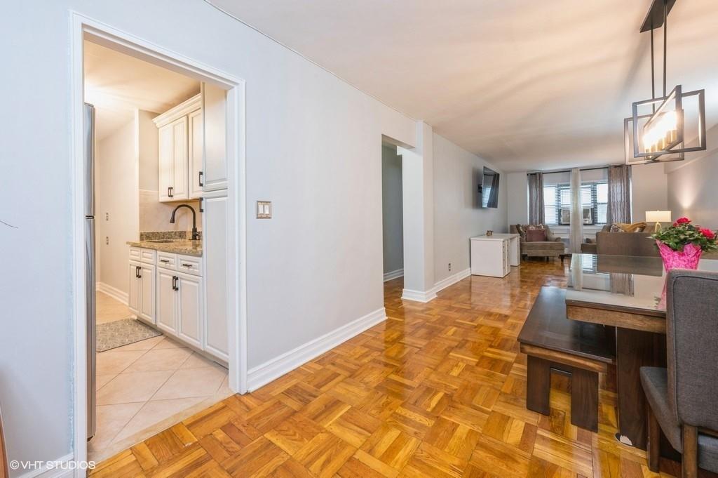 Dining space featuring sink and light parquet flooring