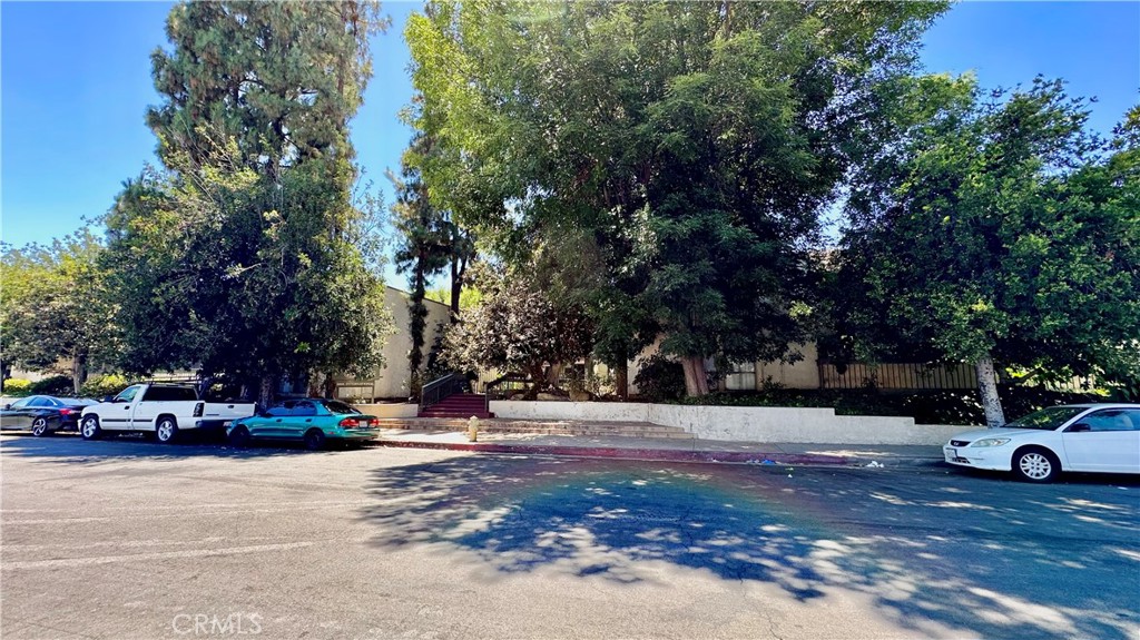 a view of road with parked cars