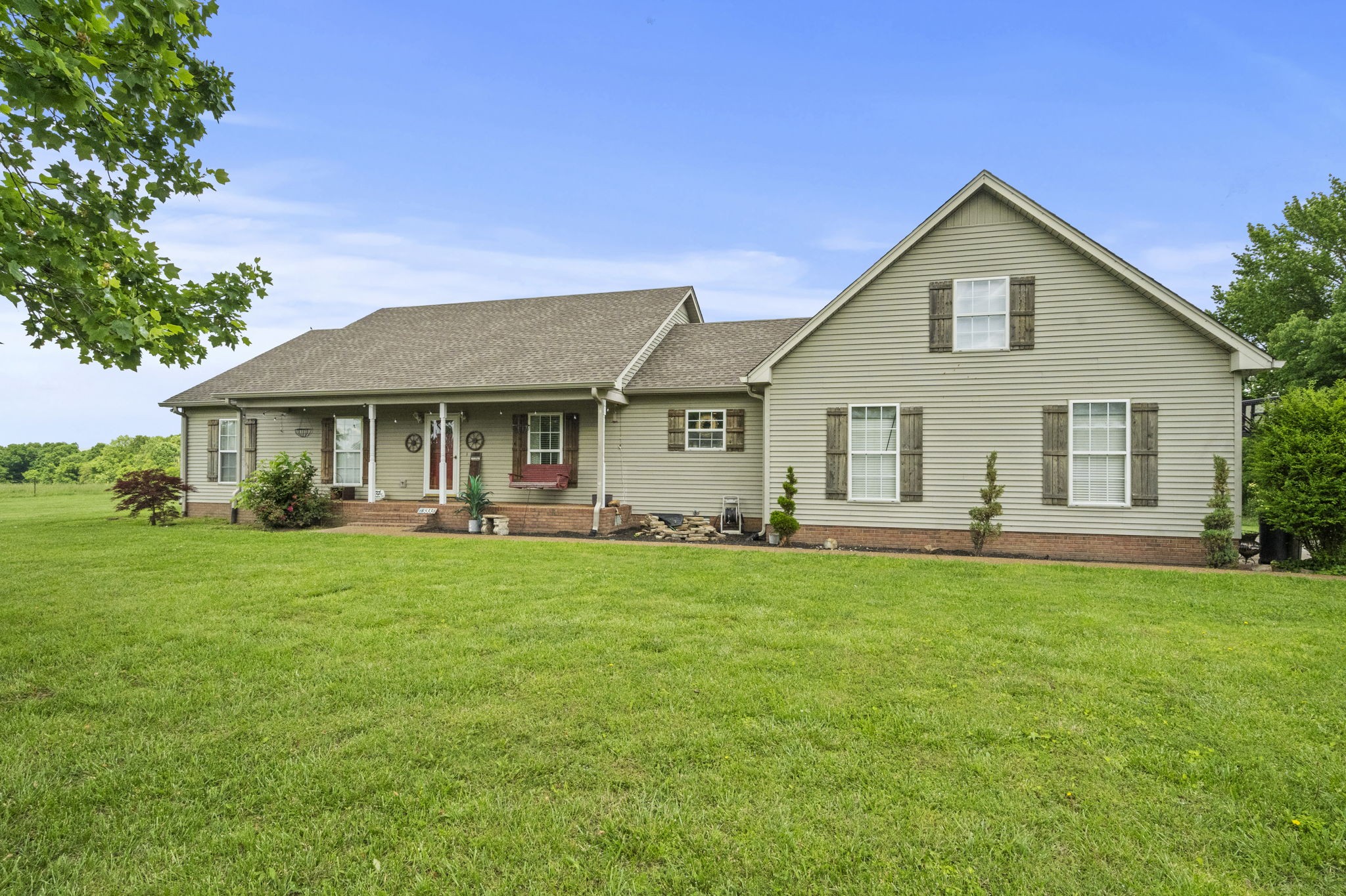 a front view of a house with a garden