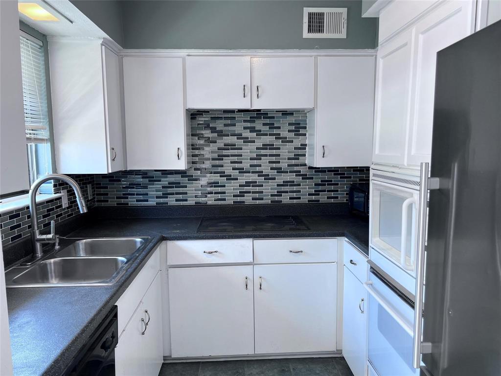 a kitchen with granite countertop a sink and a stove