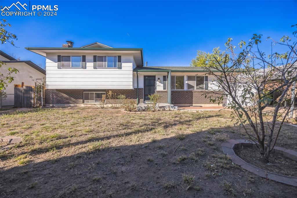 Split level home featuring a front yard