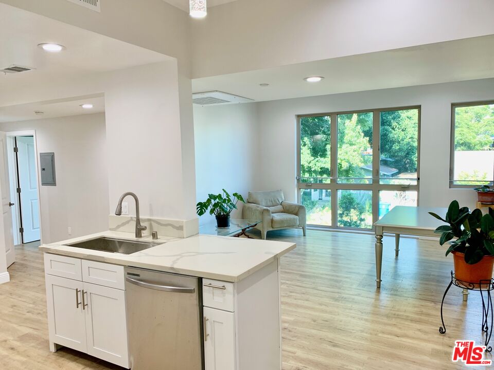 a kitchen with a sink and living room