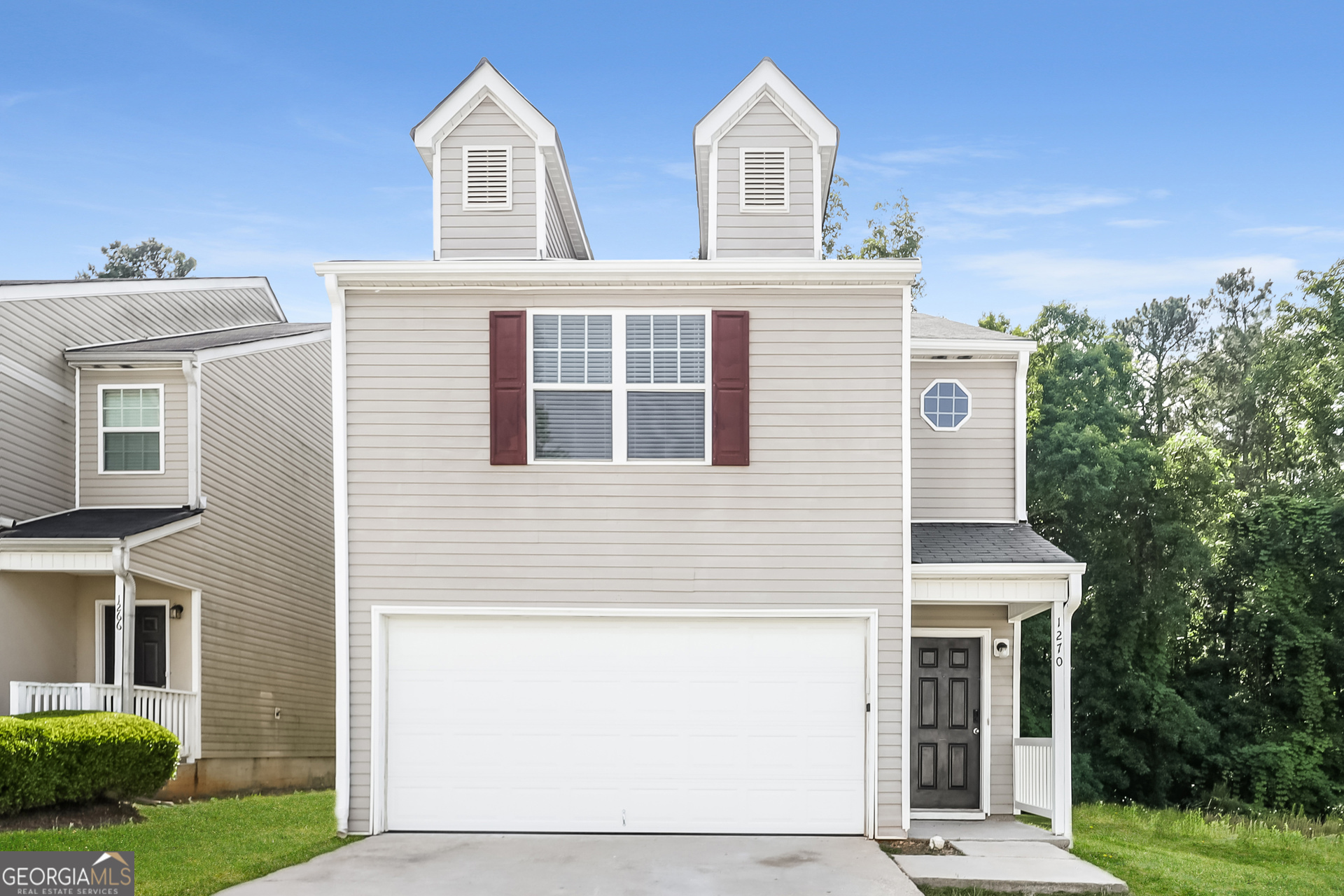 a front view of a house with a yard