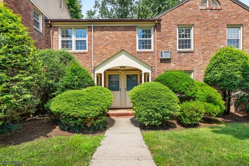 front view of a house next to a yard