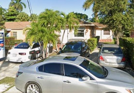 a front view of a house with parking space