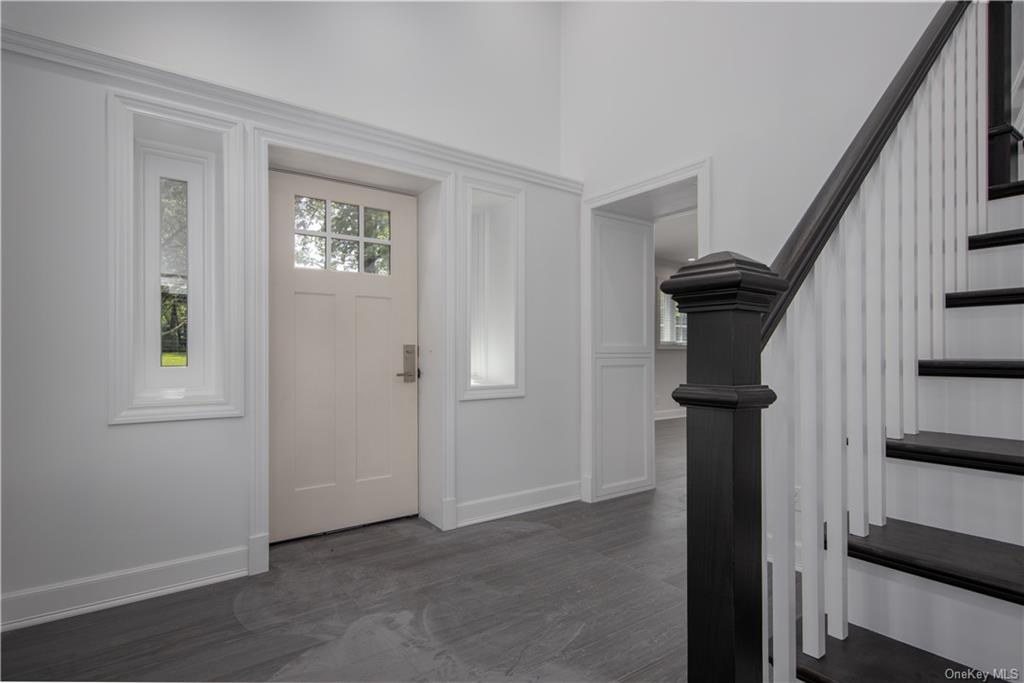 a view of entryway with wooden floor and stairs