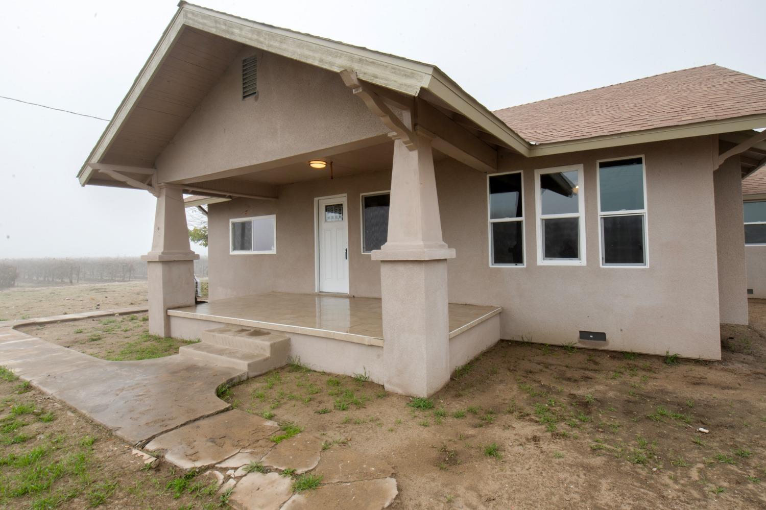 a view of a house with wooden walls and floor to ceiling window