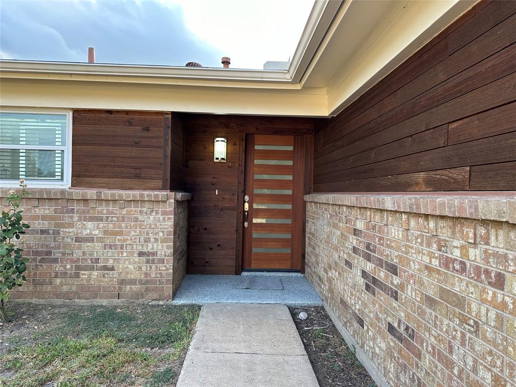 a view of front door of house with an shower