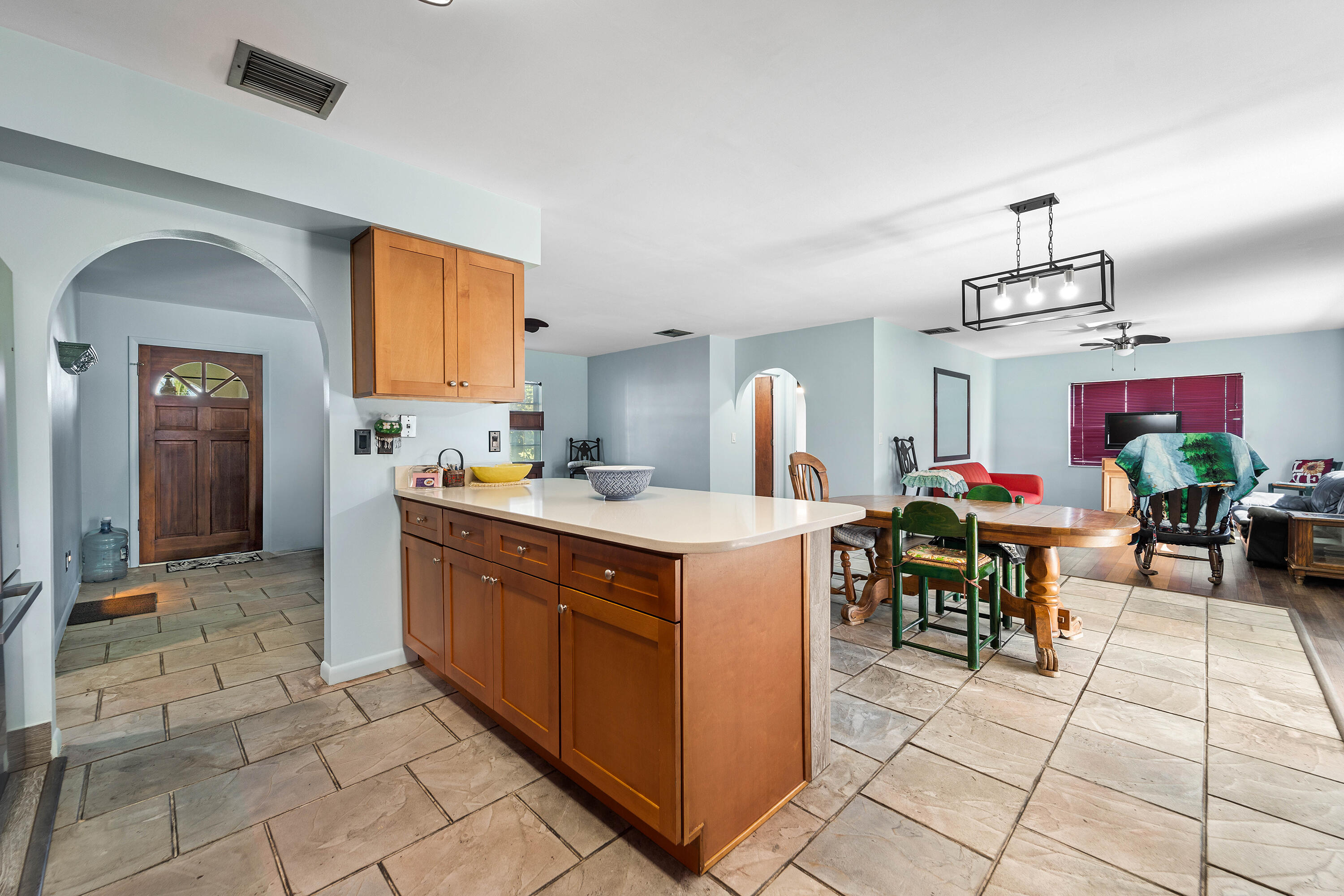 a kitchen with stainless steel appliances kitchen island granite countertop a sink and cabinets